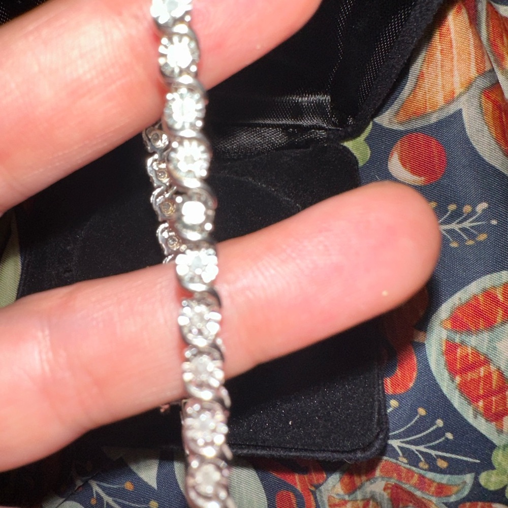 Never worn, have no use for it. Diamond and comes in original box.